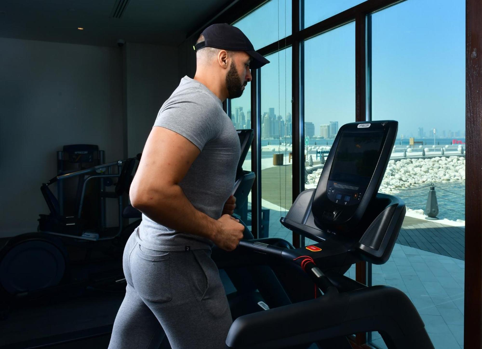 Mina Hotel And Residences By The Torch Doha Ngoại thất bức ảnh A man exercising on a treadmill